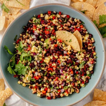 black bean and corn dip in a serving bowl with chips