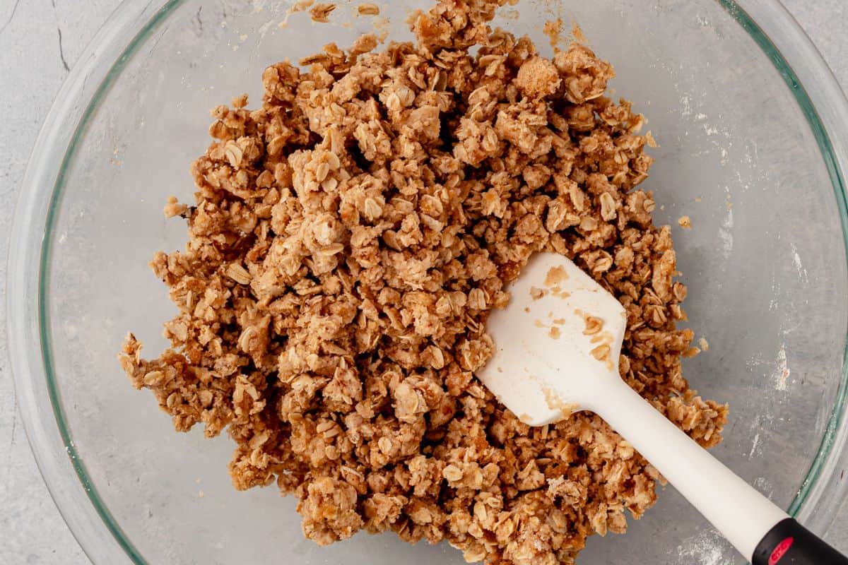 oatmeal crumb dough in a bowl with a rubber spatula