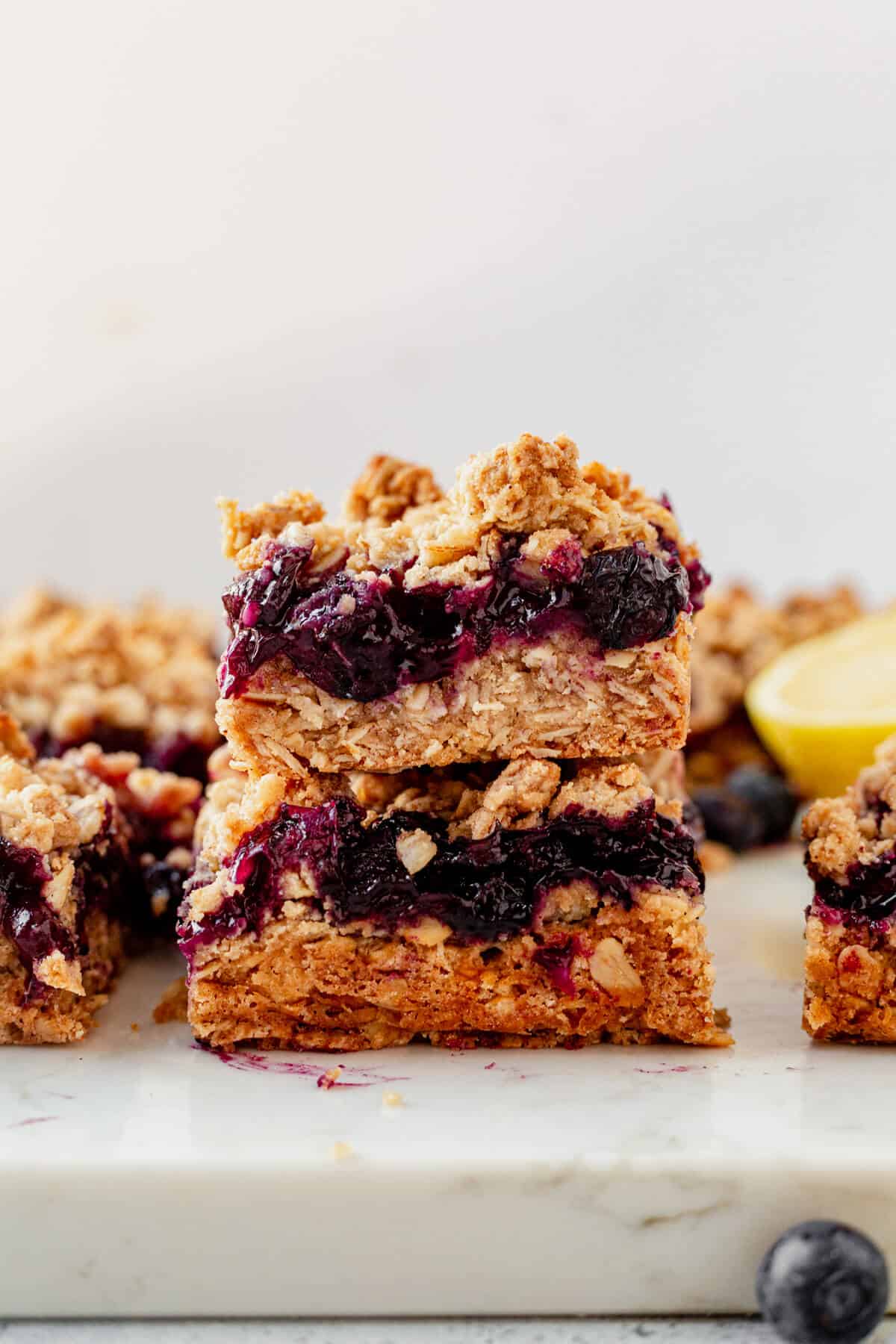two blueberry oatmeal bars stacked on a countertop