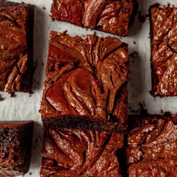 fudgy chocolate brownies with nutella swirls cut into squares.