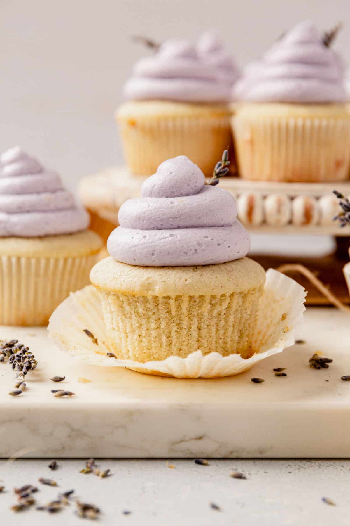 vanilla lavender cupcake unwrapped on a countertop