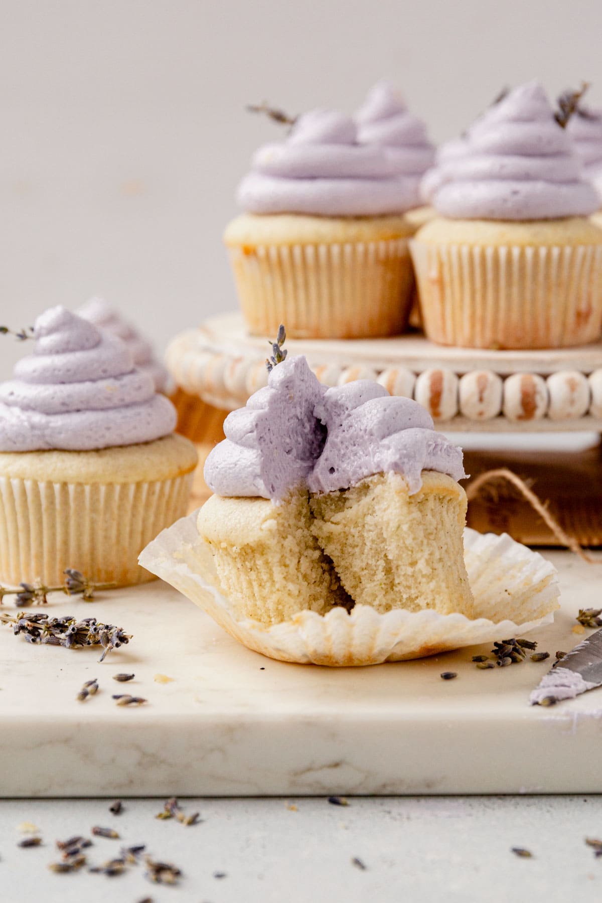 two havles of a sliced lavender cupcake on a counter