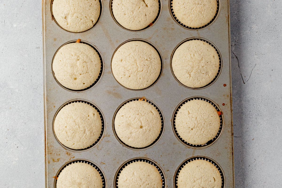 freshly baked lavender cupcakes cooling in a cupcake pan