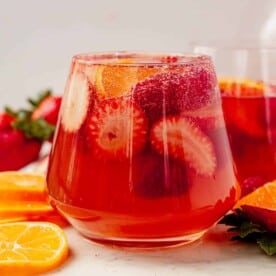 bubbly soda water on top of a glass of moscato sangria with fresh berries