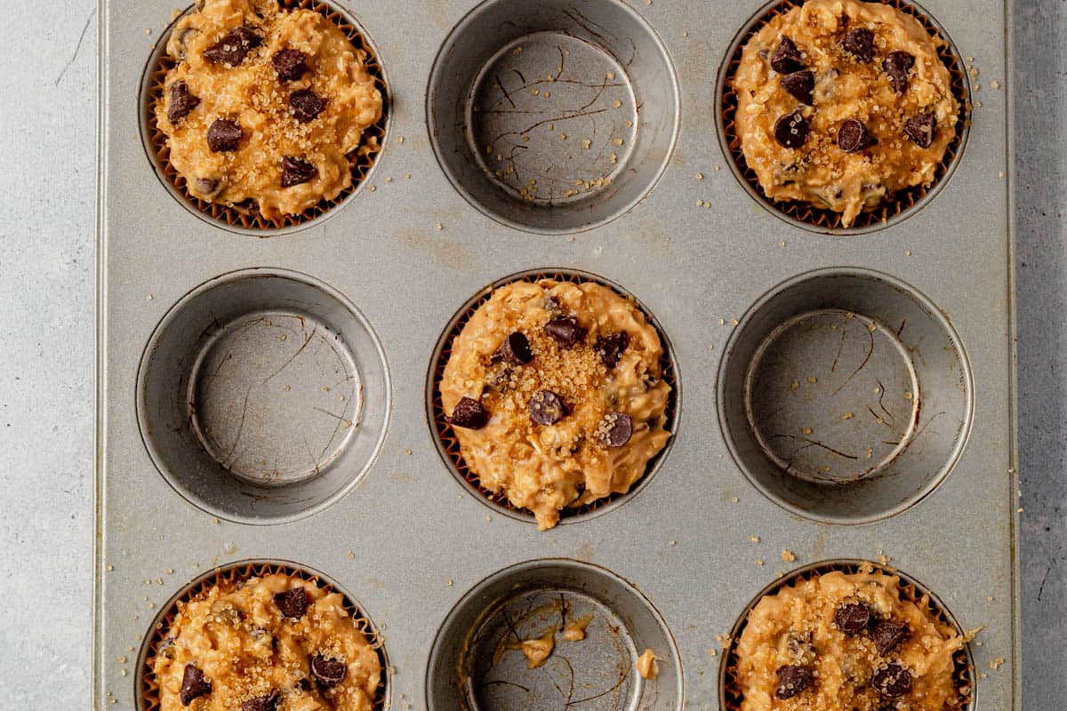 oatmeal chocolate chip muffin batter in a muffin pan