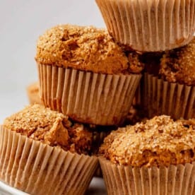 freshly baked pumpkin muffins in a pile on a plate
