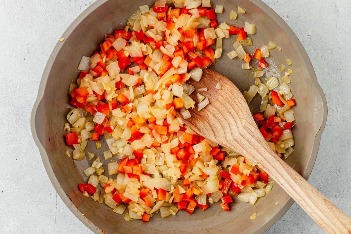 sauteed onion and peppers in a skillet