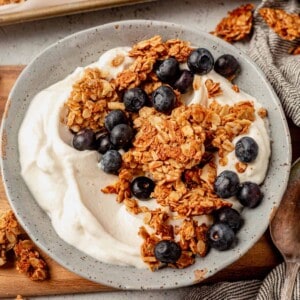 a bowl of greek yogurt, blueberries, and vanilla almond granola