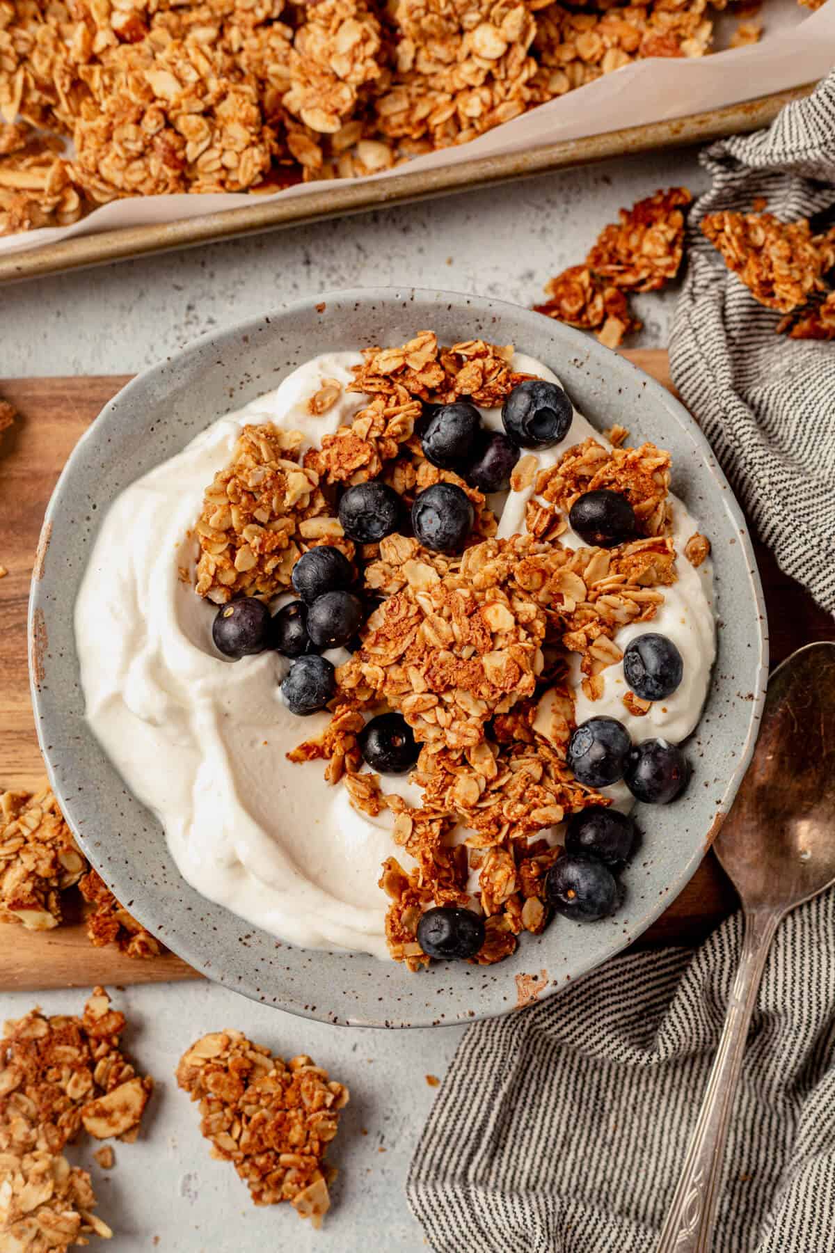 a bowl of vanilla almond granola, blueberries, and greek yogurt