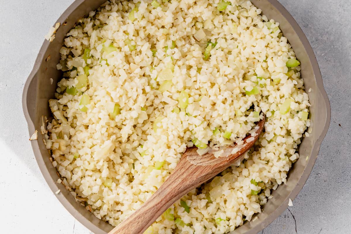 onion, celery, and cauliflower rice in a skillet
