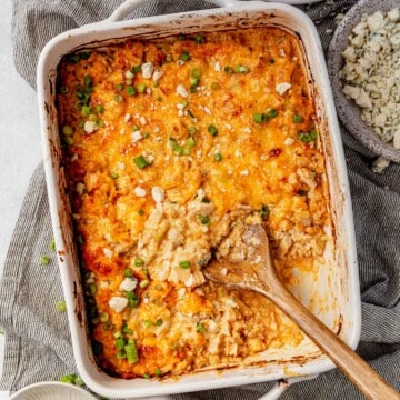freshly baked buffalo chicken casserole topped with blue cheese and green onions