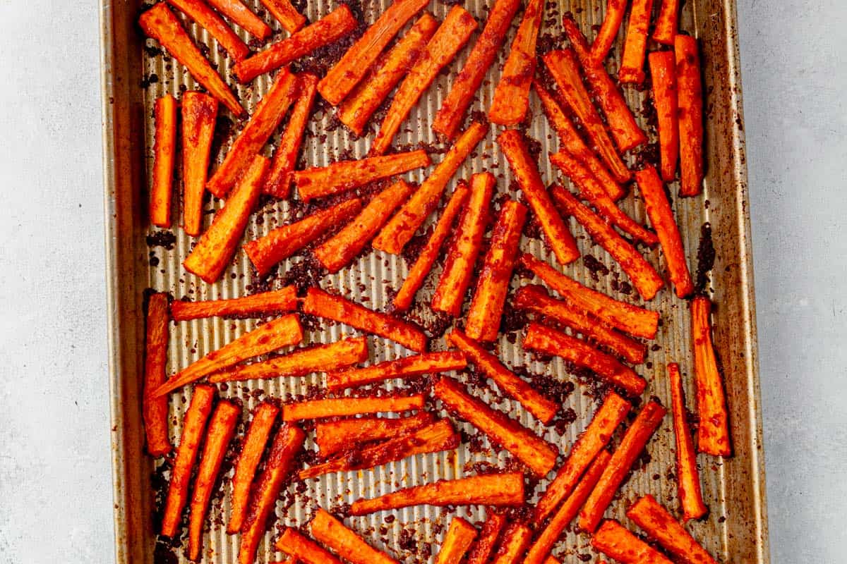 crispy baked carrot fries on a cookie sheet