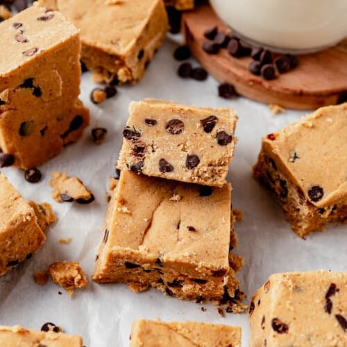 cookie dough protein bars cut into squares on parchment paper