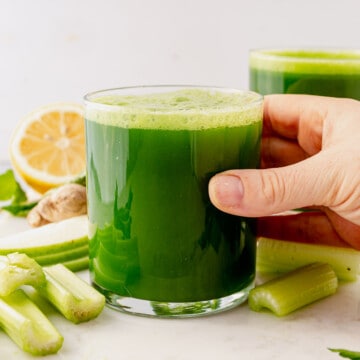 green juice in a glass on the counter