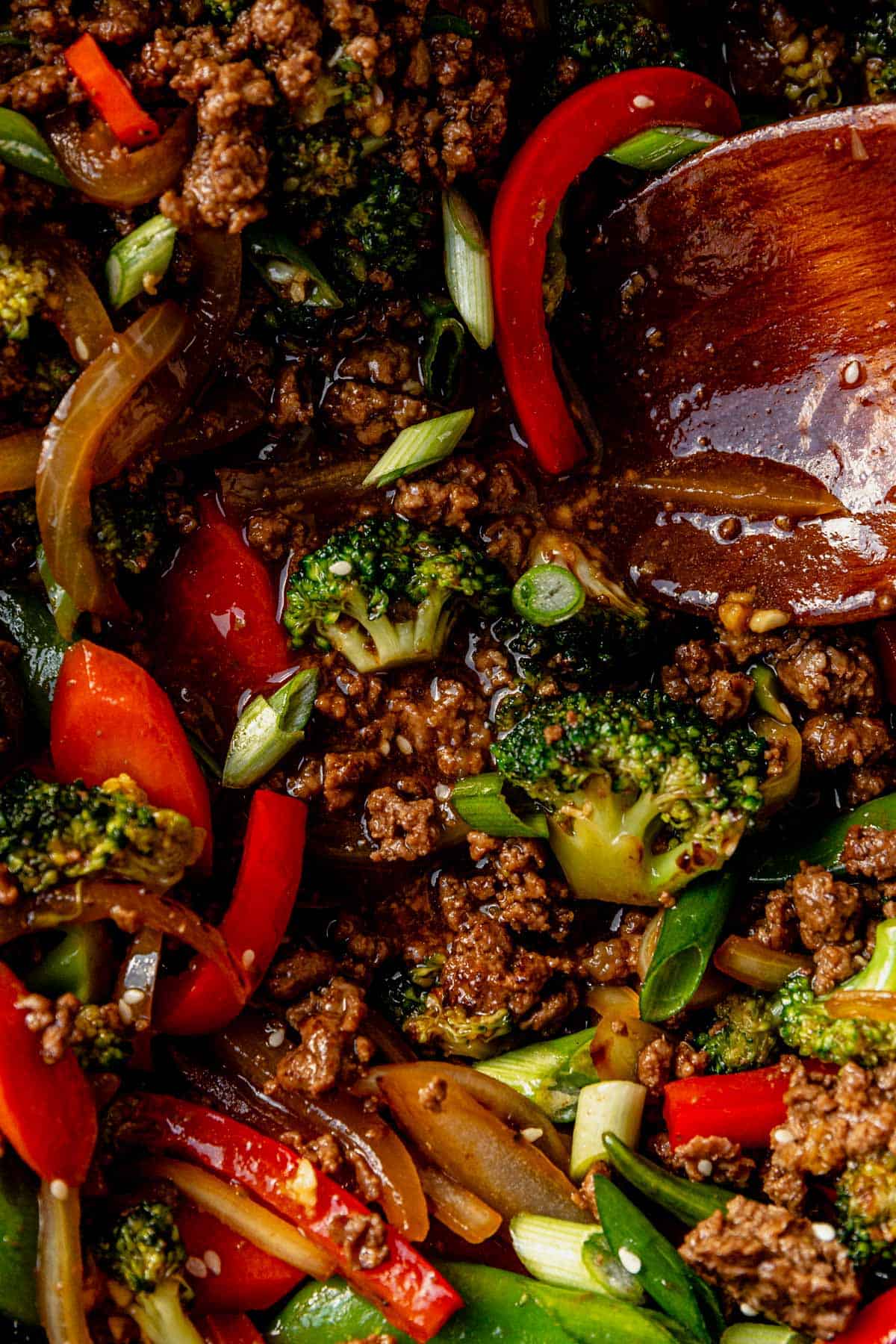 sauce ground beef stir fry in a pan with a spoon