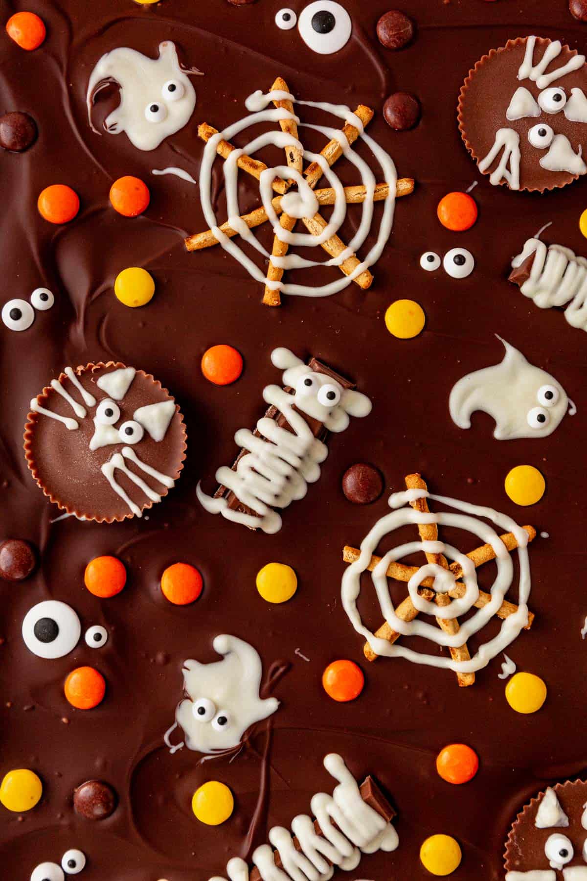 candy mummies, spider webs, ghosts, and cats on chocolate bark