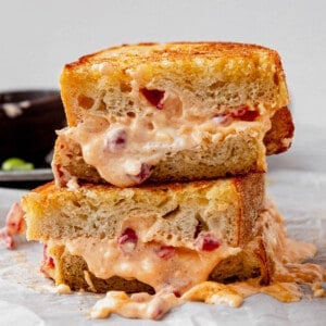 pimento grilled cheese halves stacked with melty cheese coming out