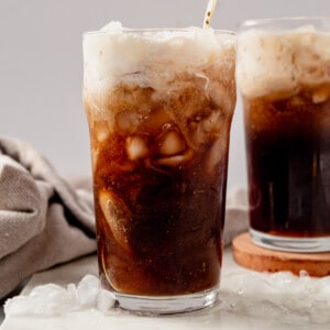 creamy root beer cocktail in a glass with crushed ice