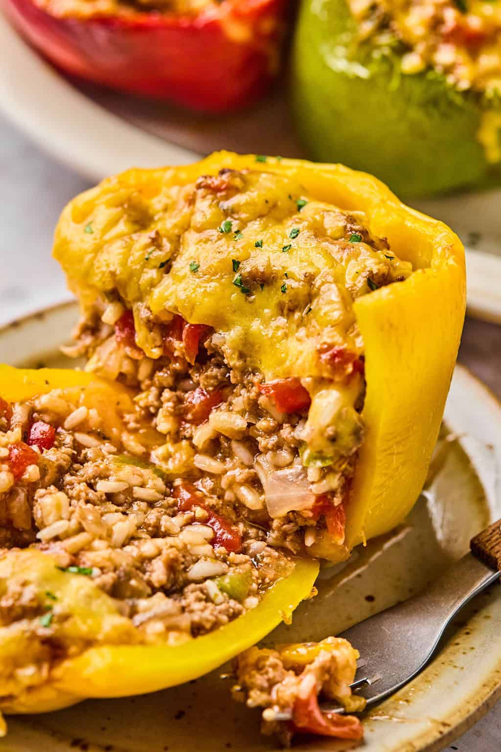 a stuffed pepper on a plate cut in half.