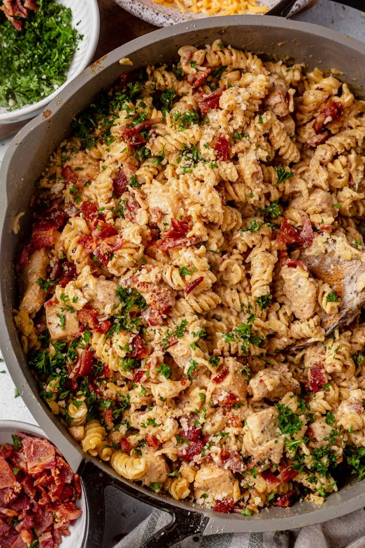 chicken bacon ranch pasta in a skillet with parsley