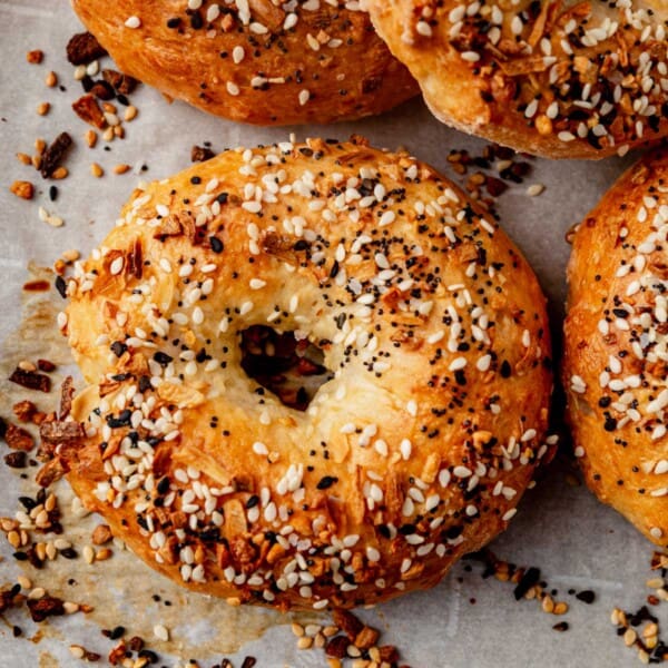 freshly baked golden brown cottage cheese bagels on parchment paper