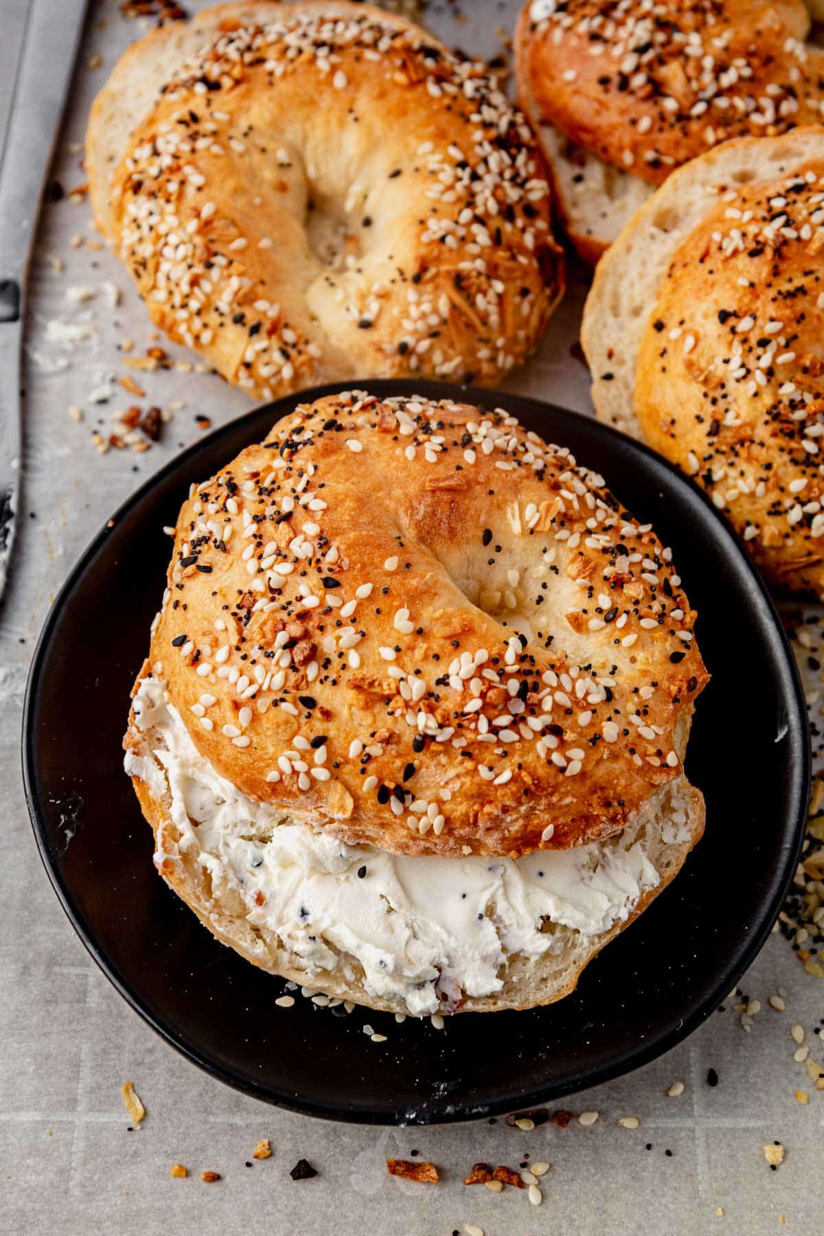freshly baked cottage cheese bagels with cream cheese spread in the middle of one