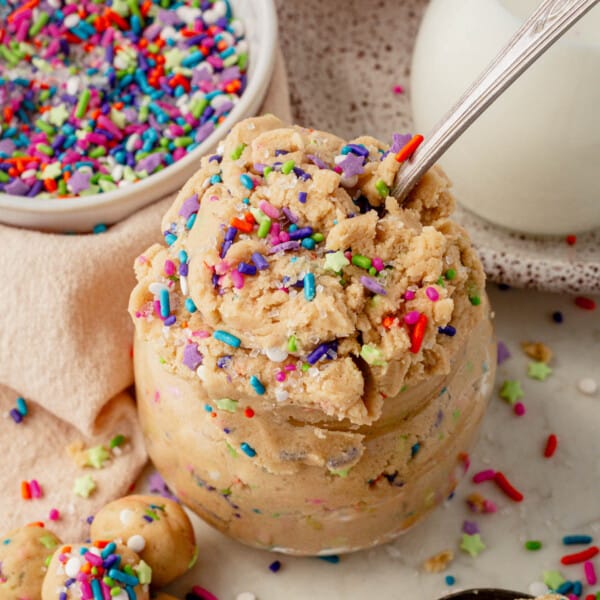 a jar of edible sugar cookie dough topped with sprinkles