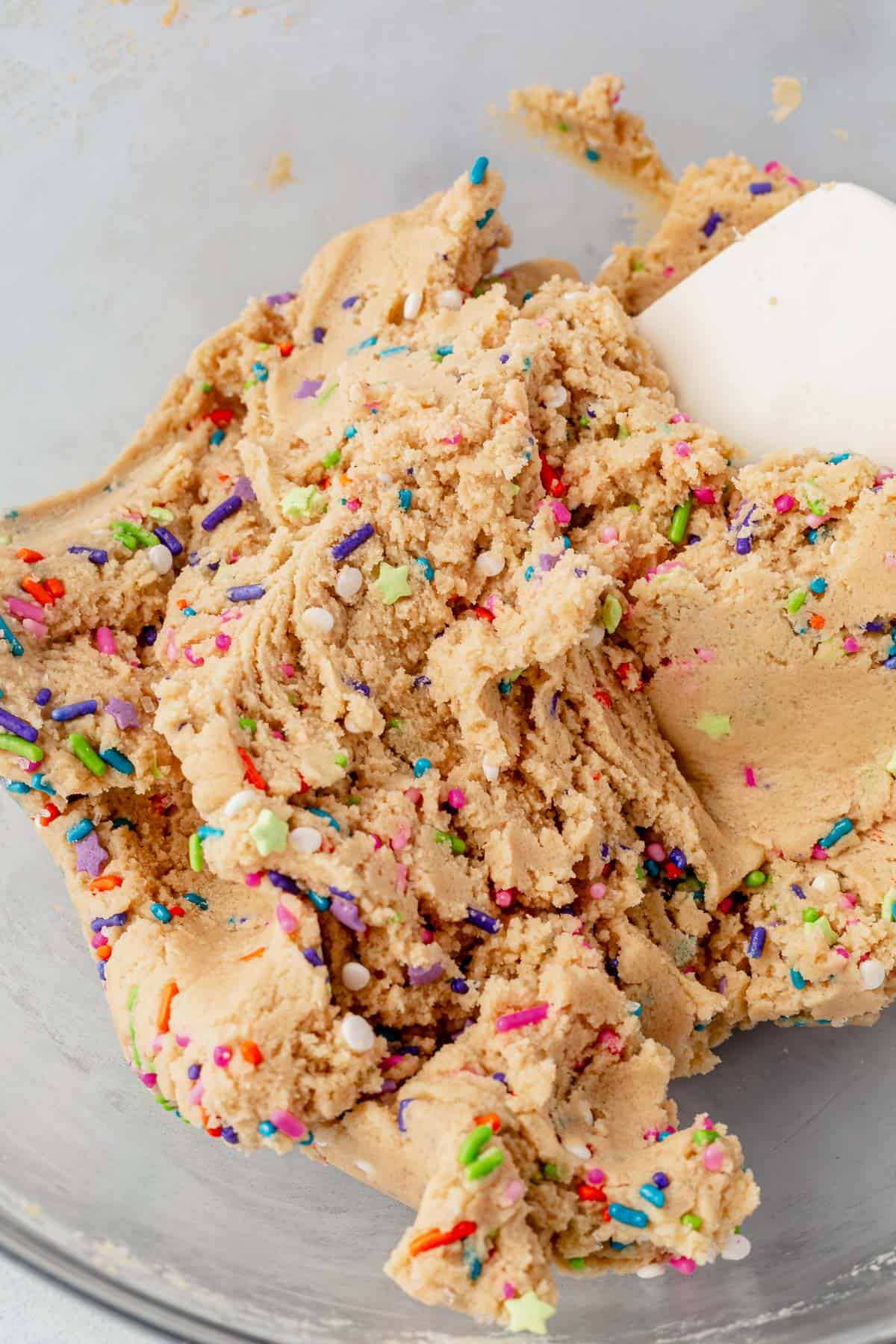 mixing sprinkles into edible sugar cookie dough