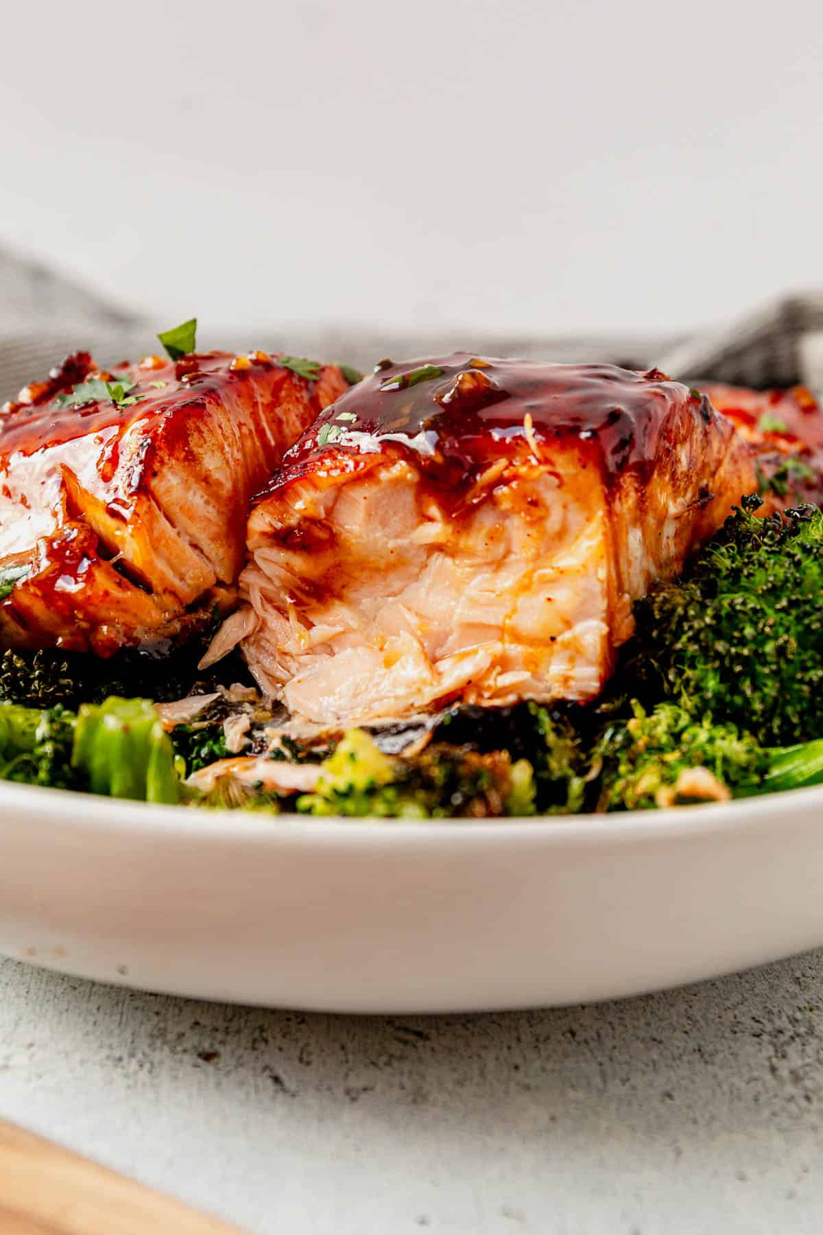 two pieces of honey glazed salmon on a bed of broccoli
