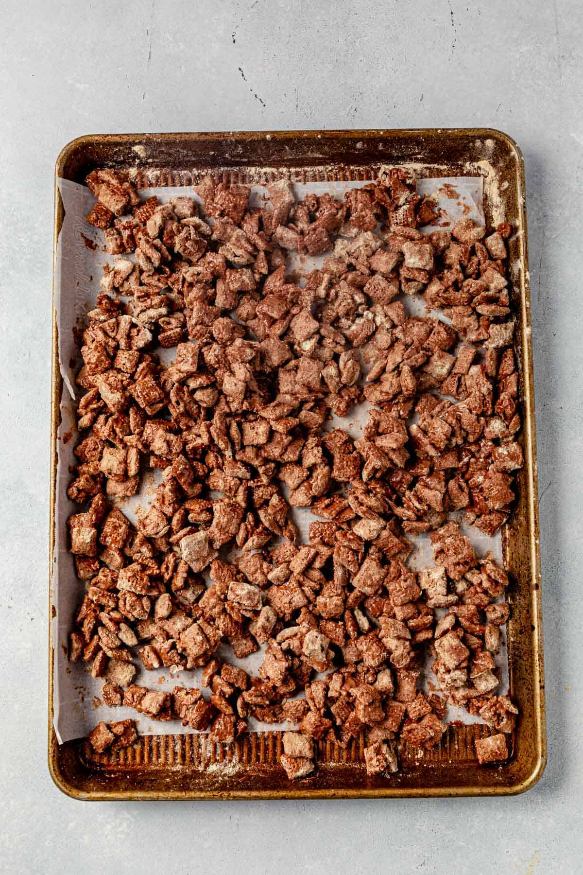 protein puppy chow on a parchment lined cookie sheet
