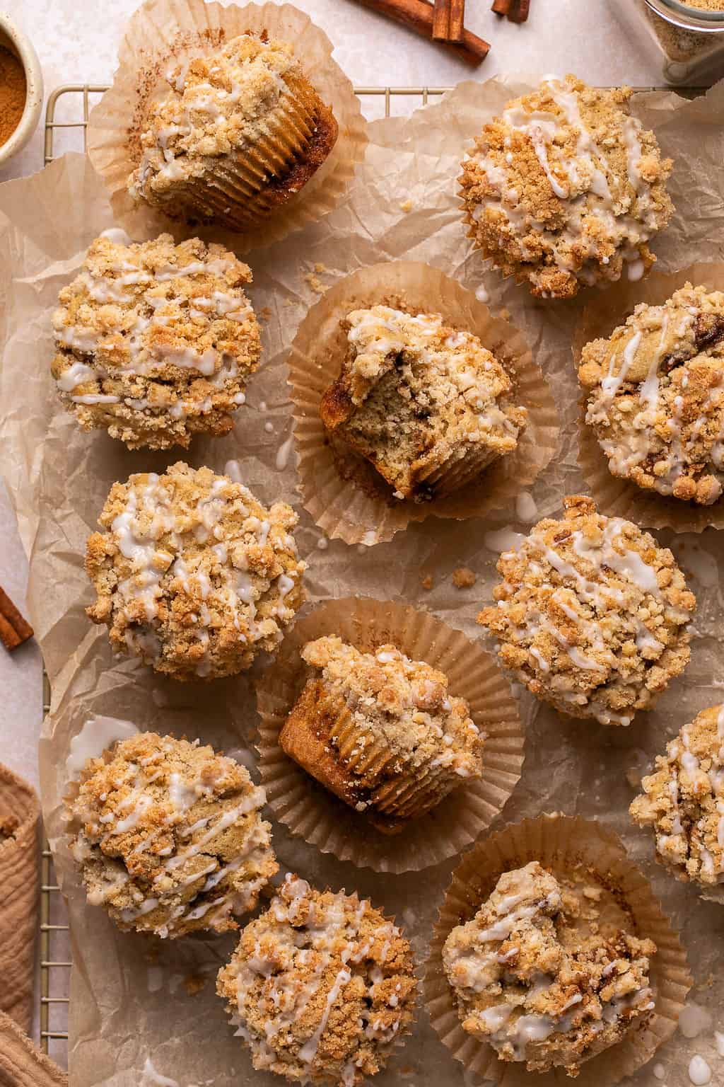 a batch of coffee cake muffins cooling on a wire rack