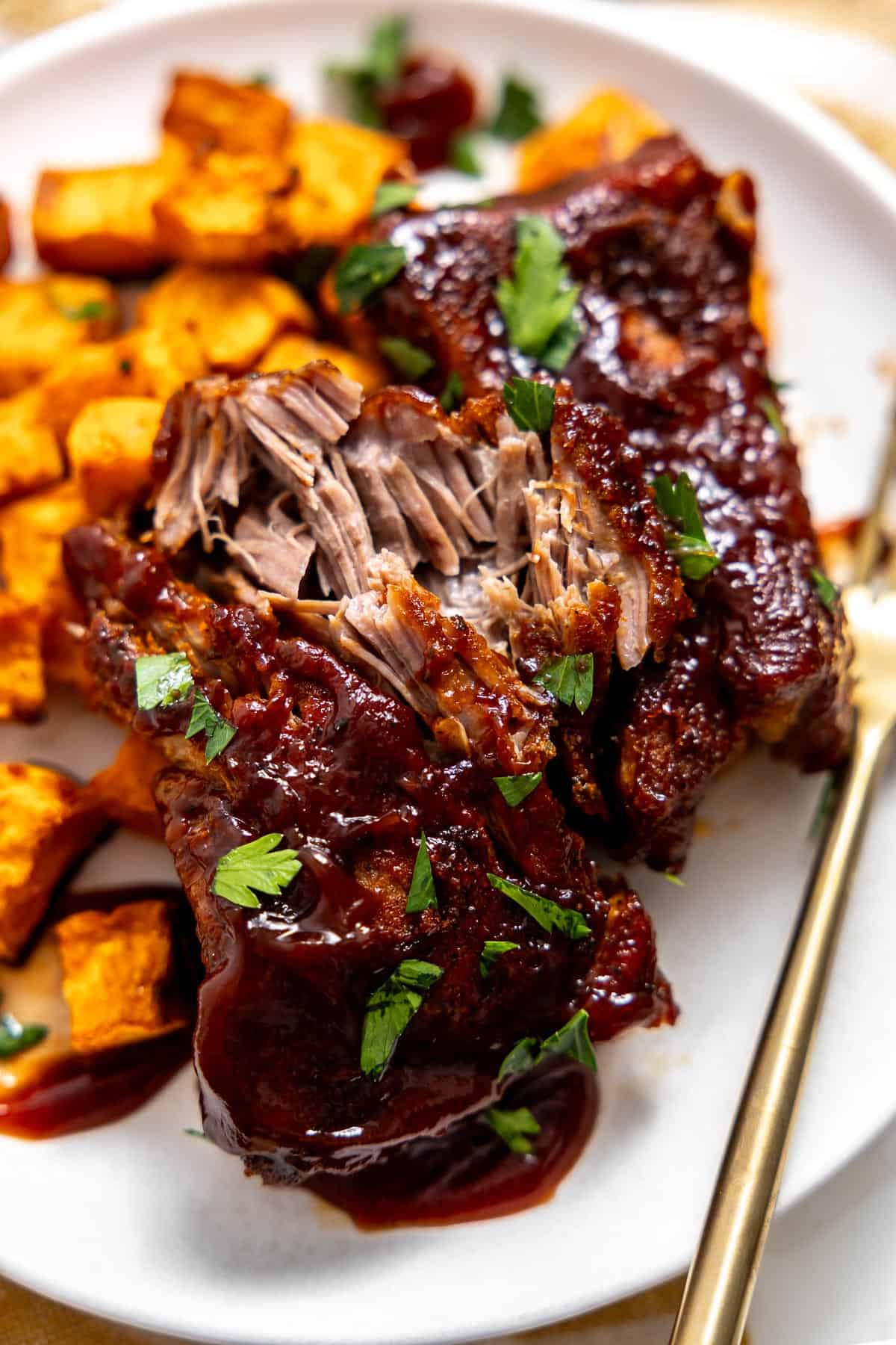 instant pot country style ribs on a plate with sweet potatoes