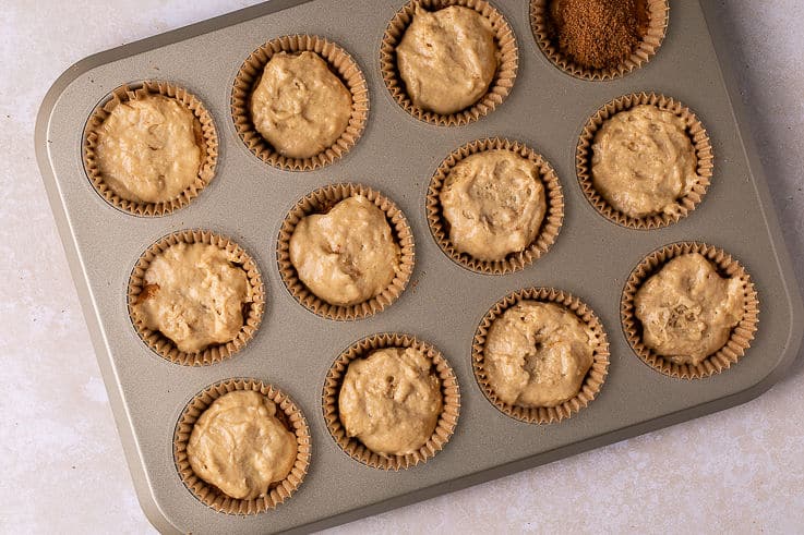 coffee cake muffin batter in a muffin pan.