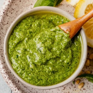 homemade basil pesto in a dish with a spoon
