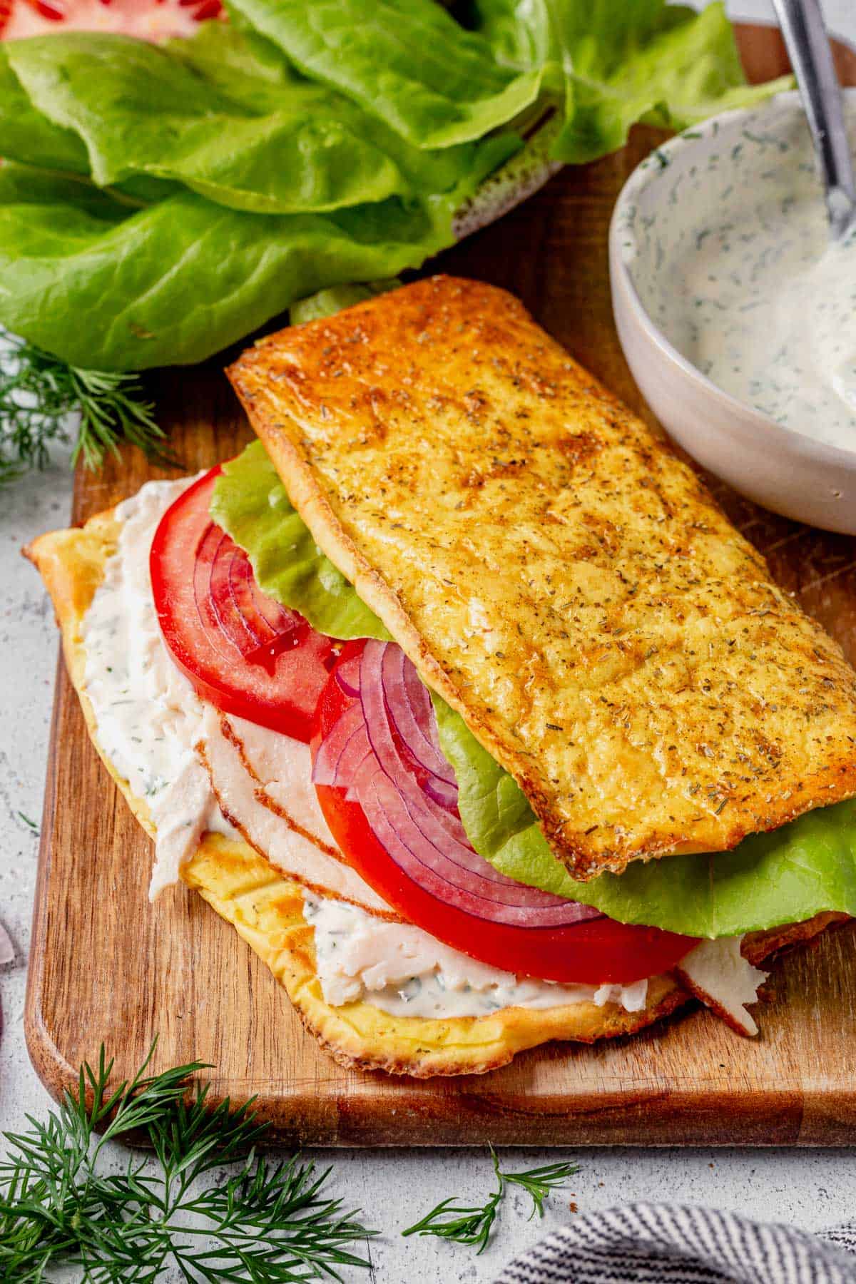 cottage cheese flatbread sandwich with lettuce and tomato