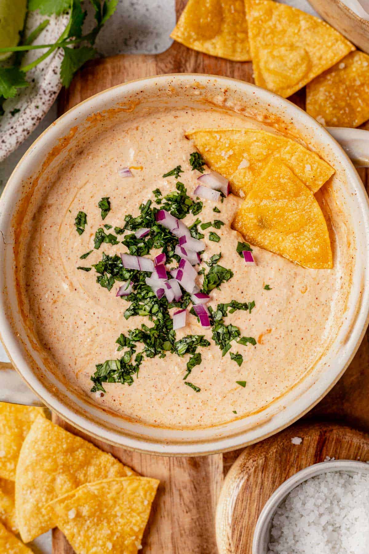 cottage cheese queso in a bowl with homemade tortilla chips