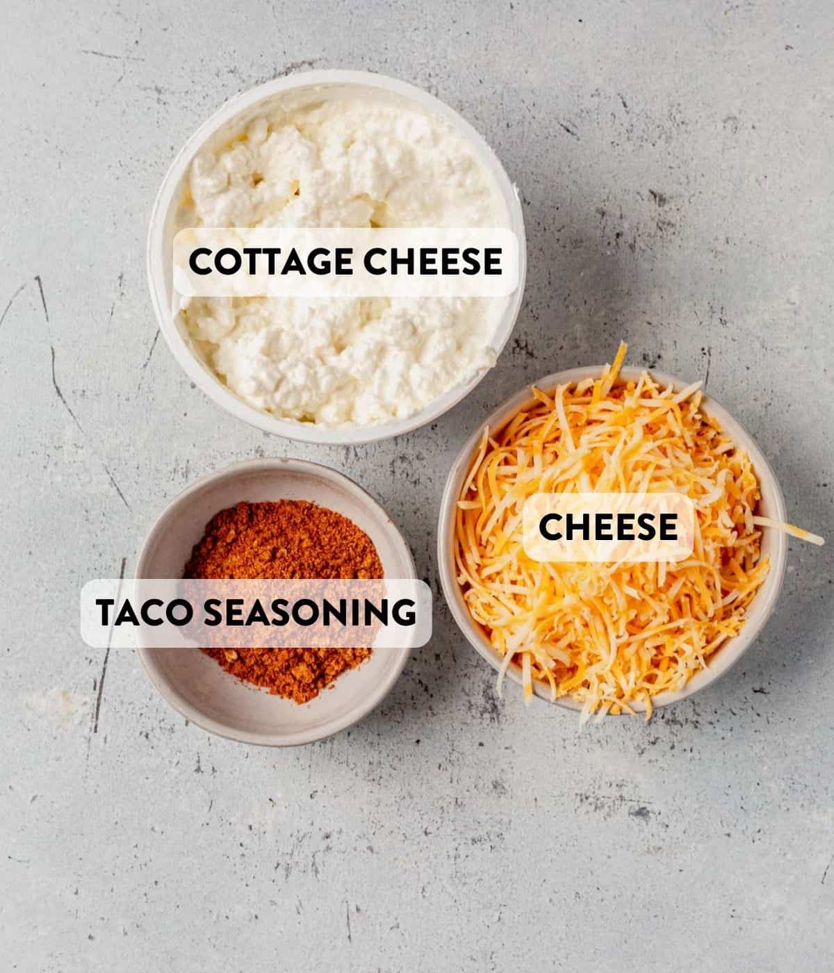cottage cheese, taco seasoning, and shredded cheese on a counter
