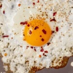 feta fried eggs cooking in a pan
