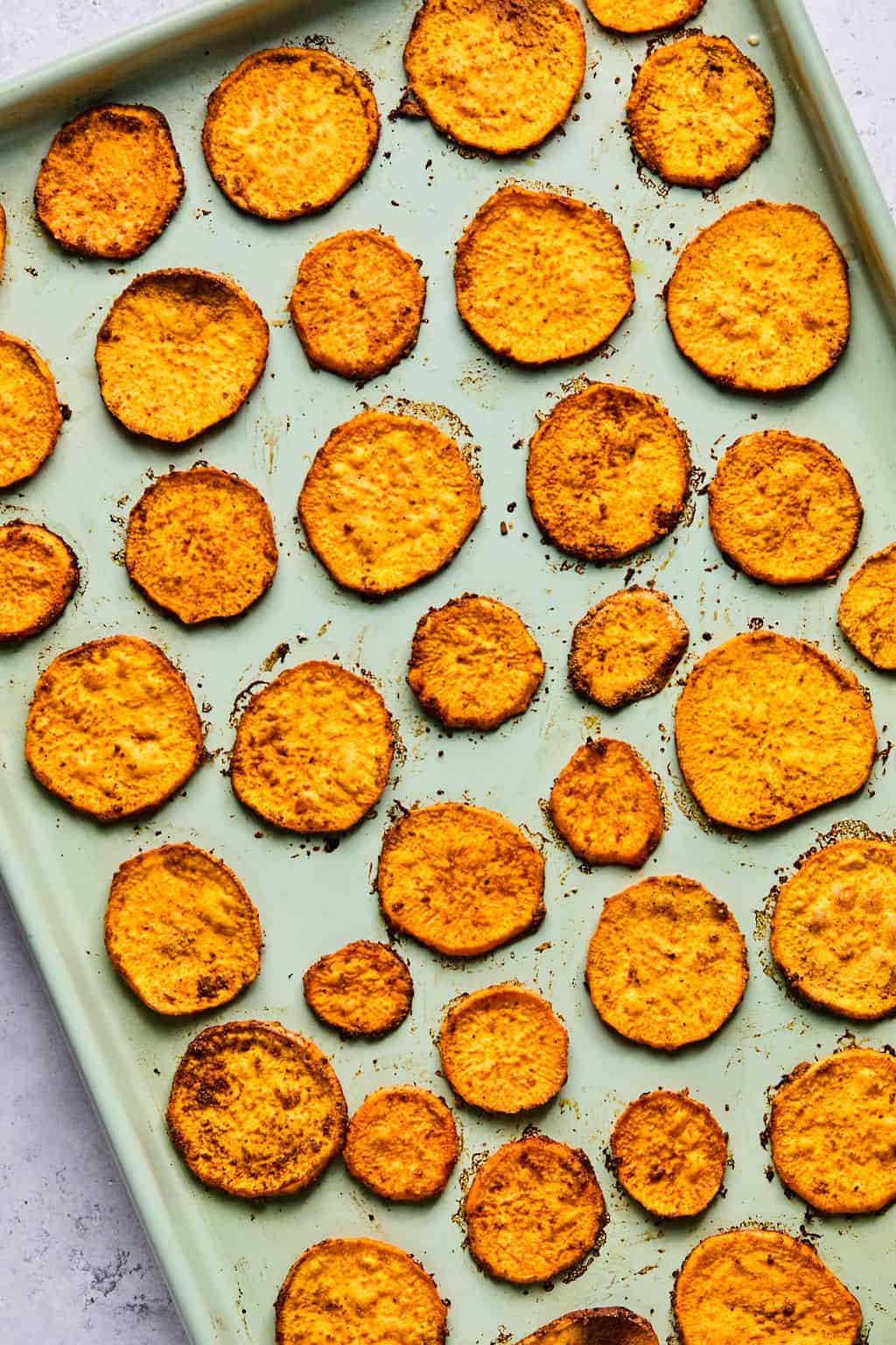 baked sweet potato chips on a sheet pan.