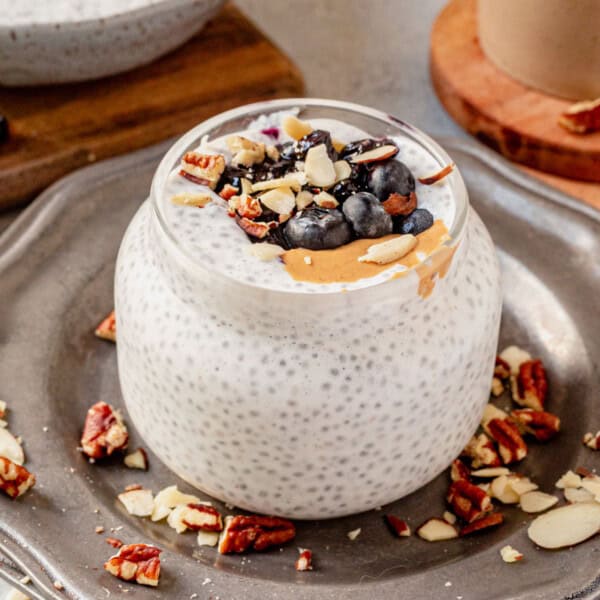 chia yogurt in a jar with blueberries and nut butter