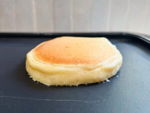 cottage cheese pancake cooking on a griddle