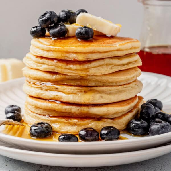 a stack of cottage cheese pancakes with butter and syrup