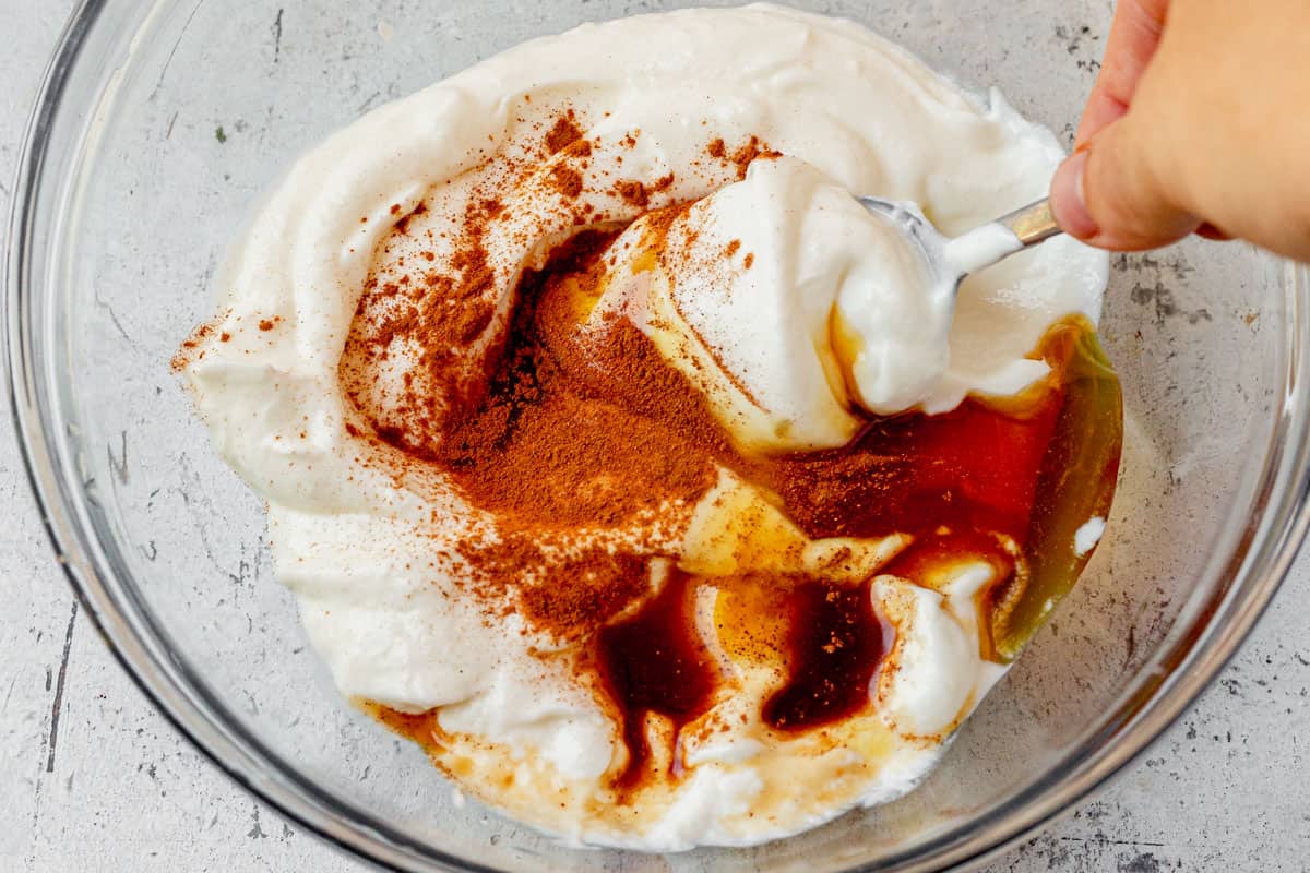 mixing fruit dip with yogurt in a bowl