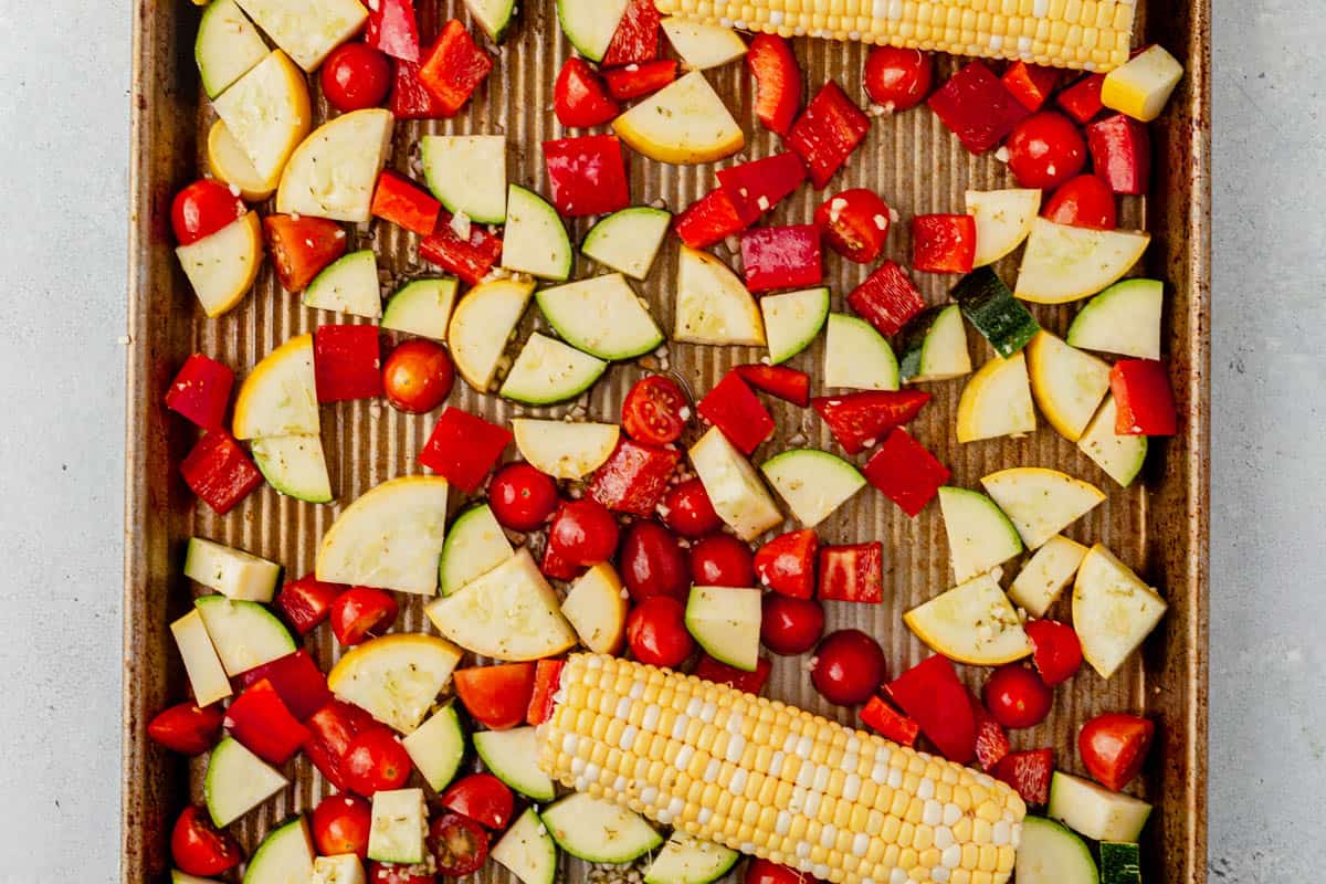 chopped vegetables on a sheet pan before roasting