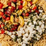 roasted vegetables, orzo, and dressing in a serving bowl