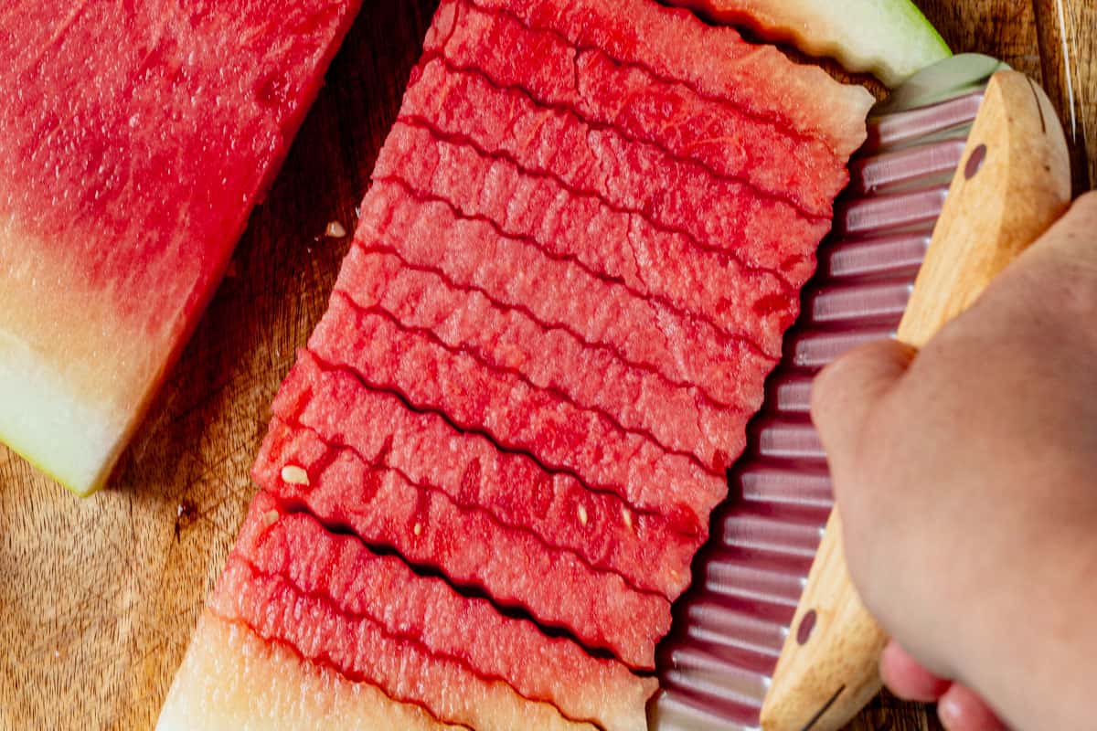 cutting the rind off of watermelon fries