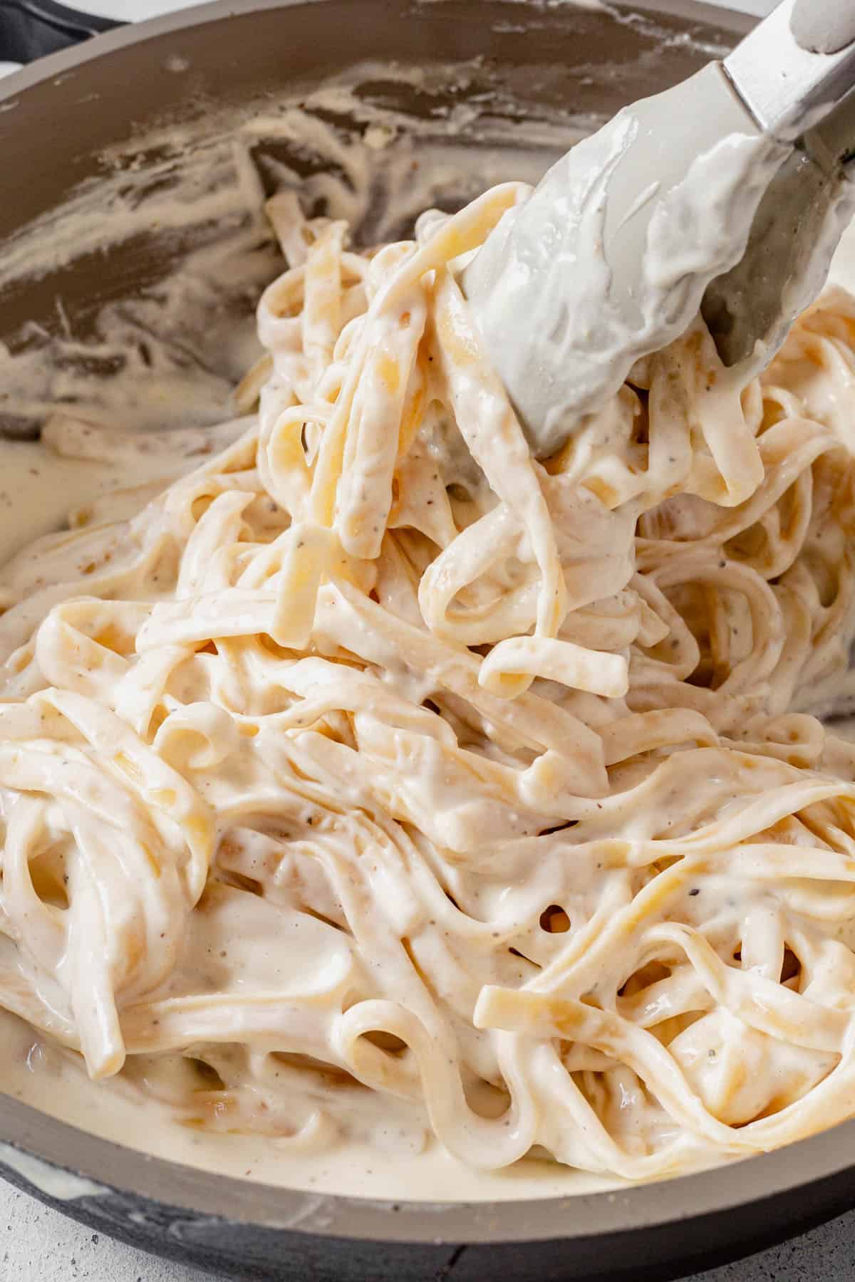 tossing paste in cottage cheese alfredo