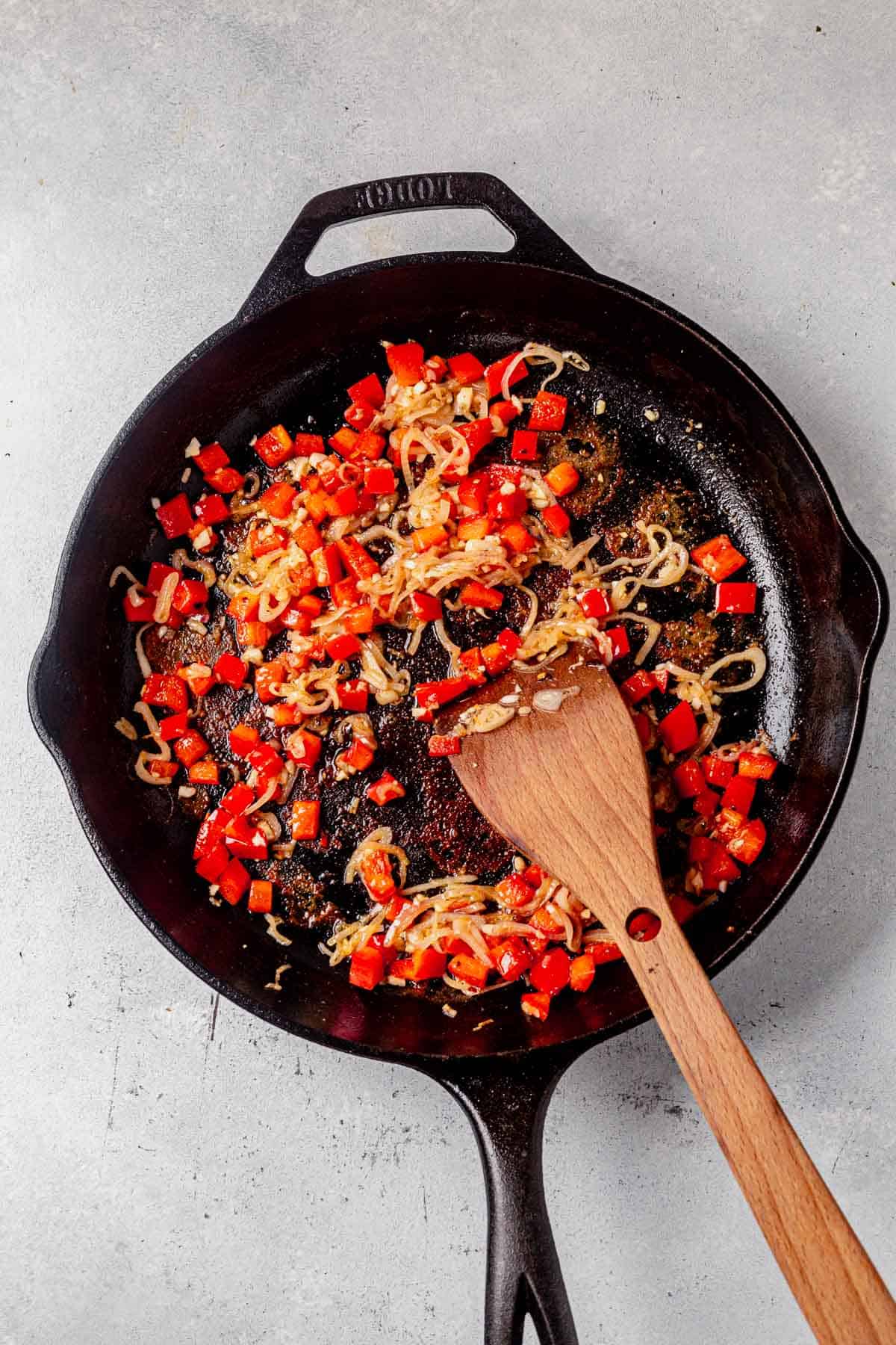 sauteed red peppers and shallots in a skillet.