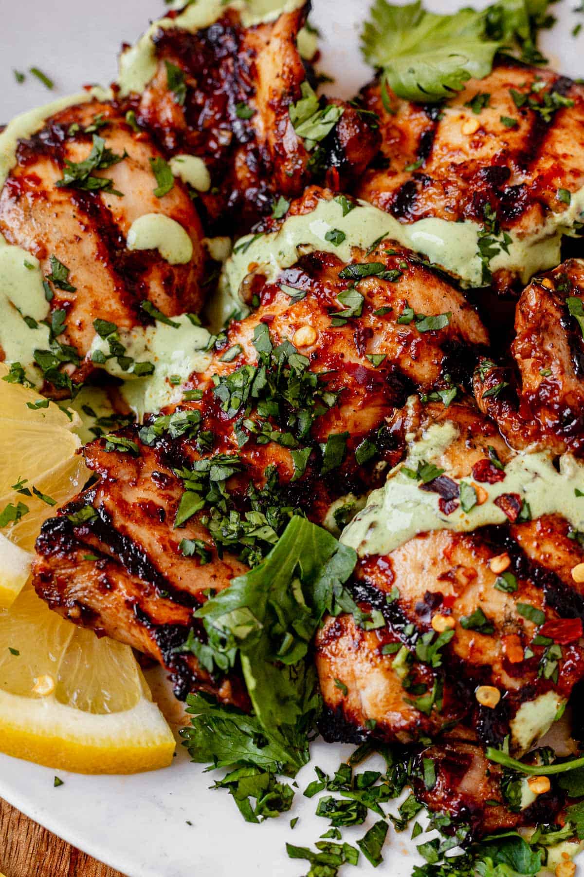 harissa honey chicken on a late with green goddess sauce