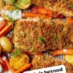 herb crusted salmon with cooked carrots and garlic roasted potatoes on a sheet pan